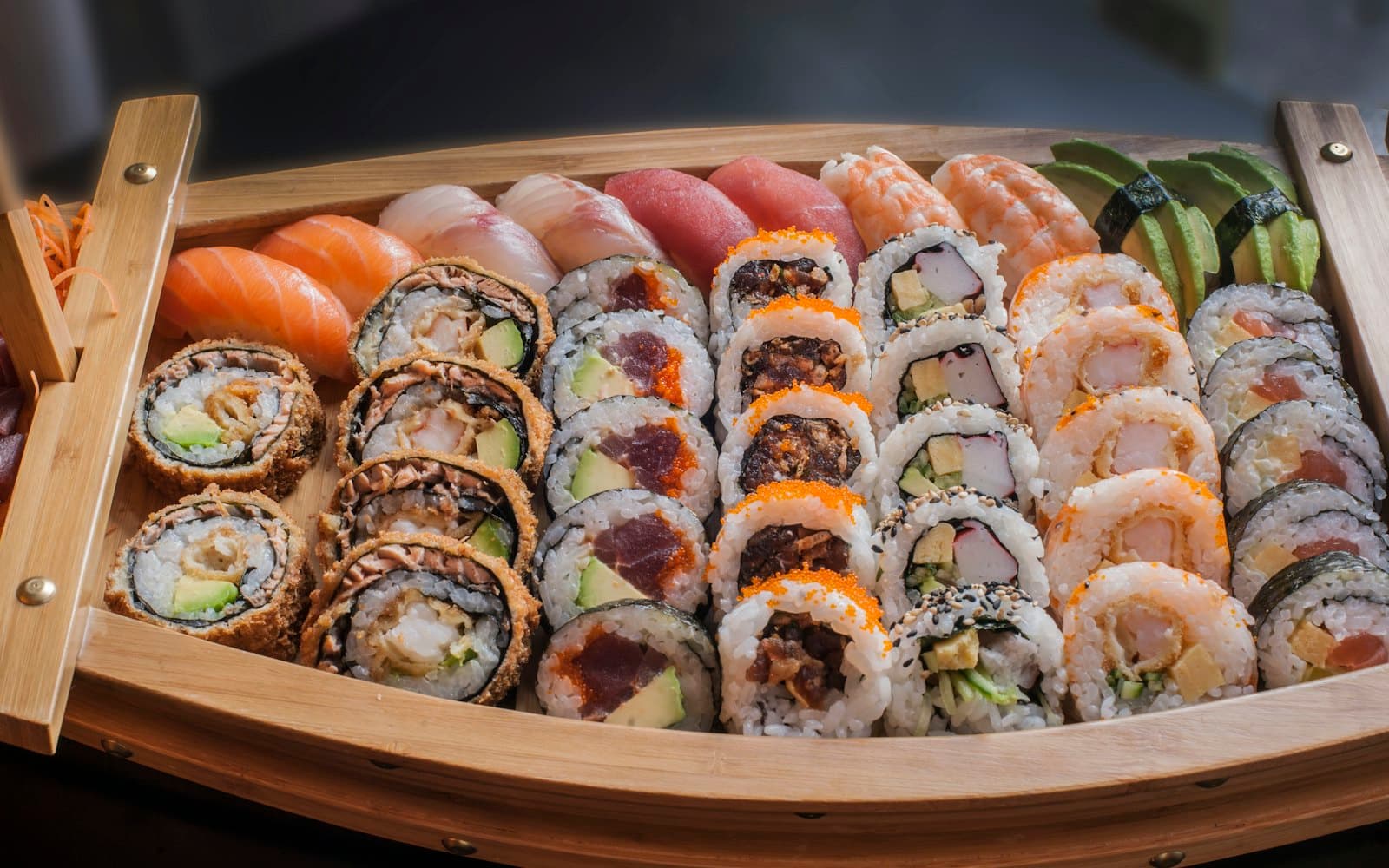 A wooden sushi boat filled with maki, uramaki and nigiri at KOKORO Sushi Bar, Sofia